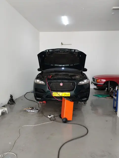 Jaguar F-Pace in a service bay with a battery support unit connected